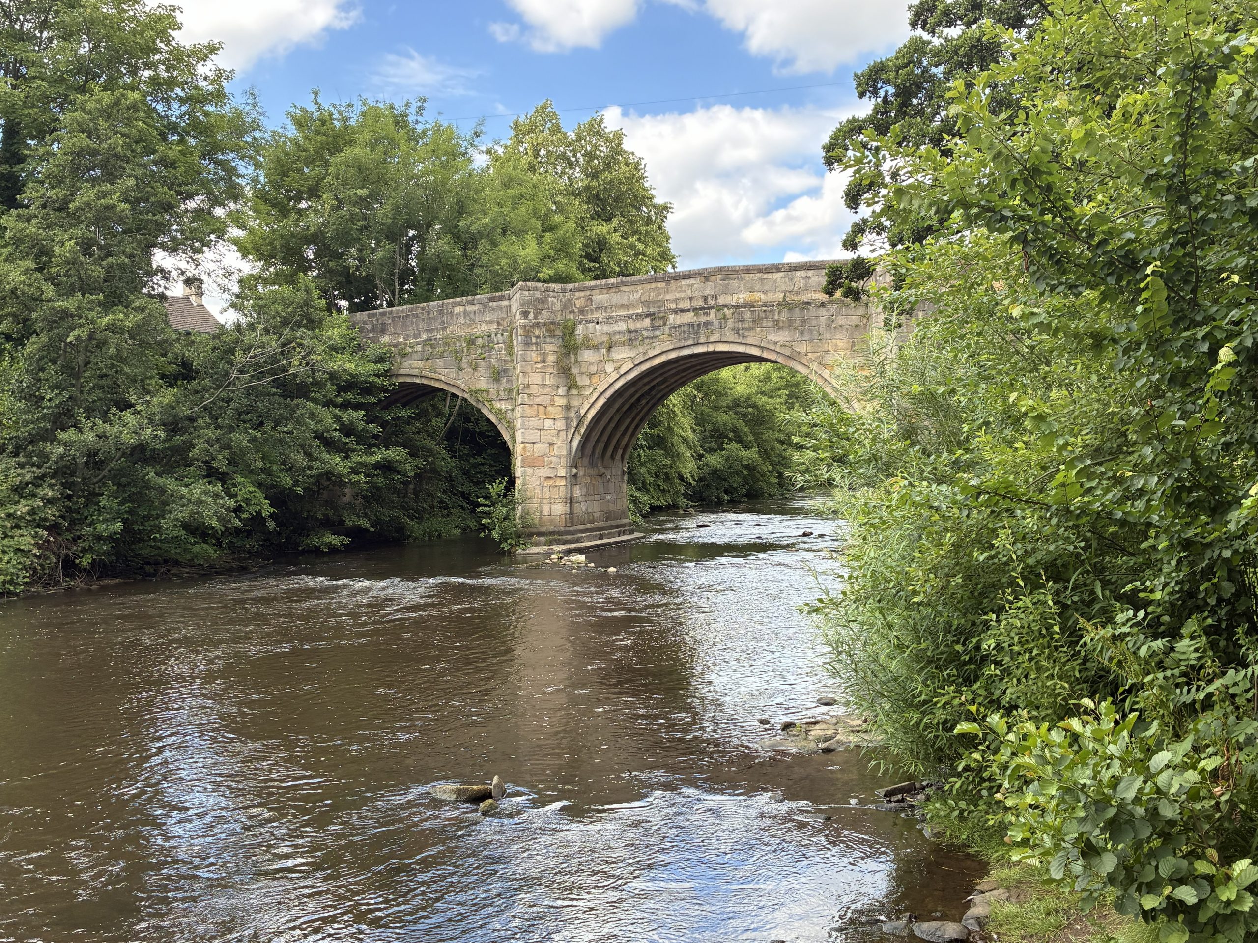 Explore the Chatsworth Area - Historic stone bridge over the River Derwent in Baslow, one of the Peak District's most desirable villages.