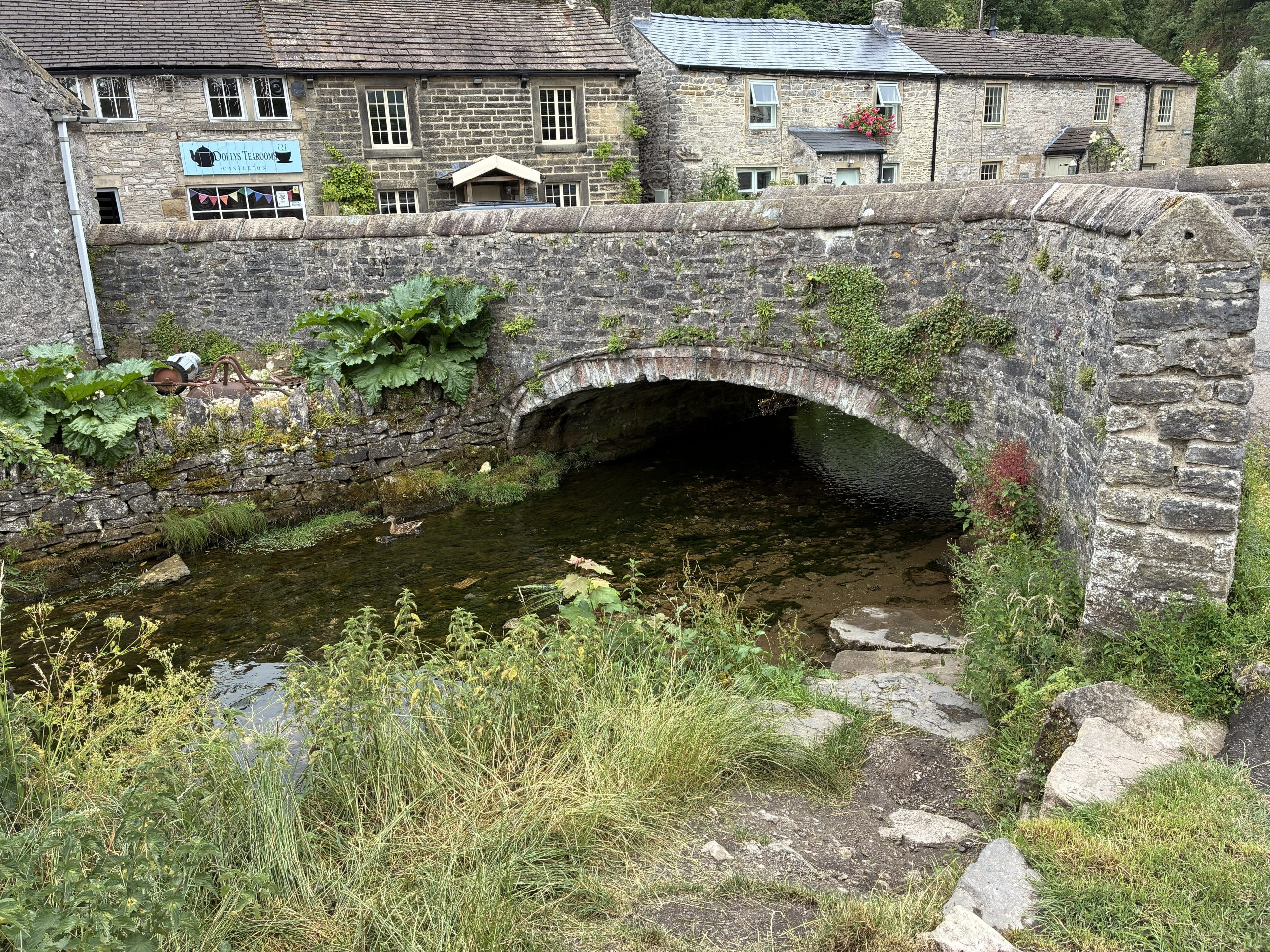 Your Guide to Castleton – historic stone bridge crossing Peakshole Water in the heart of Castleton.