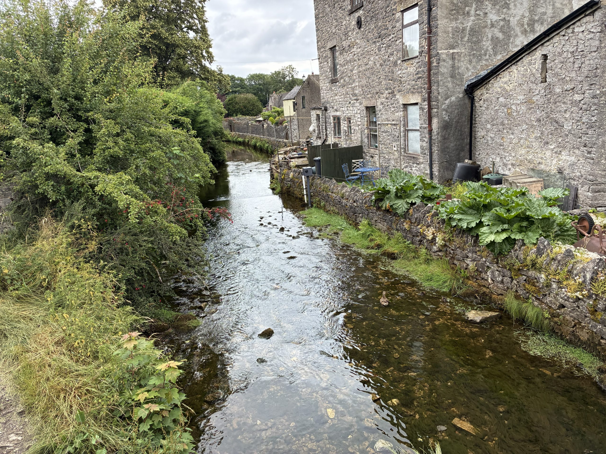 Your Guide to Castleton – view along Peakshole Water from the historic bridge in the centre of Castleton.