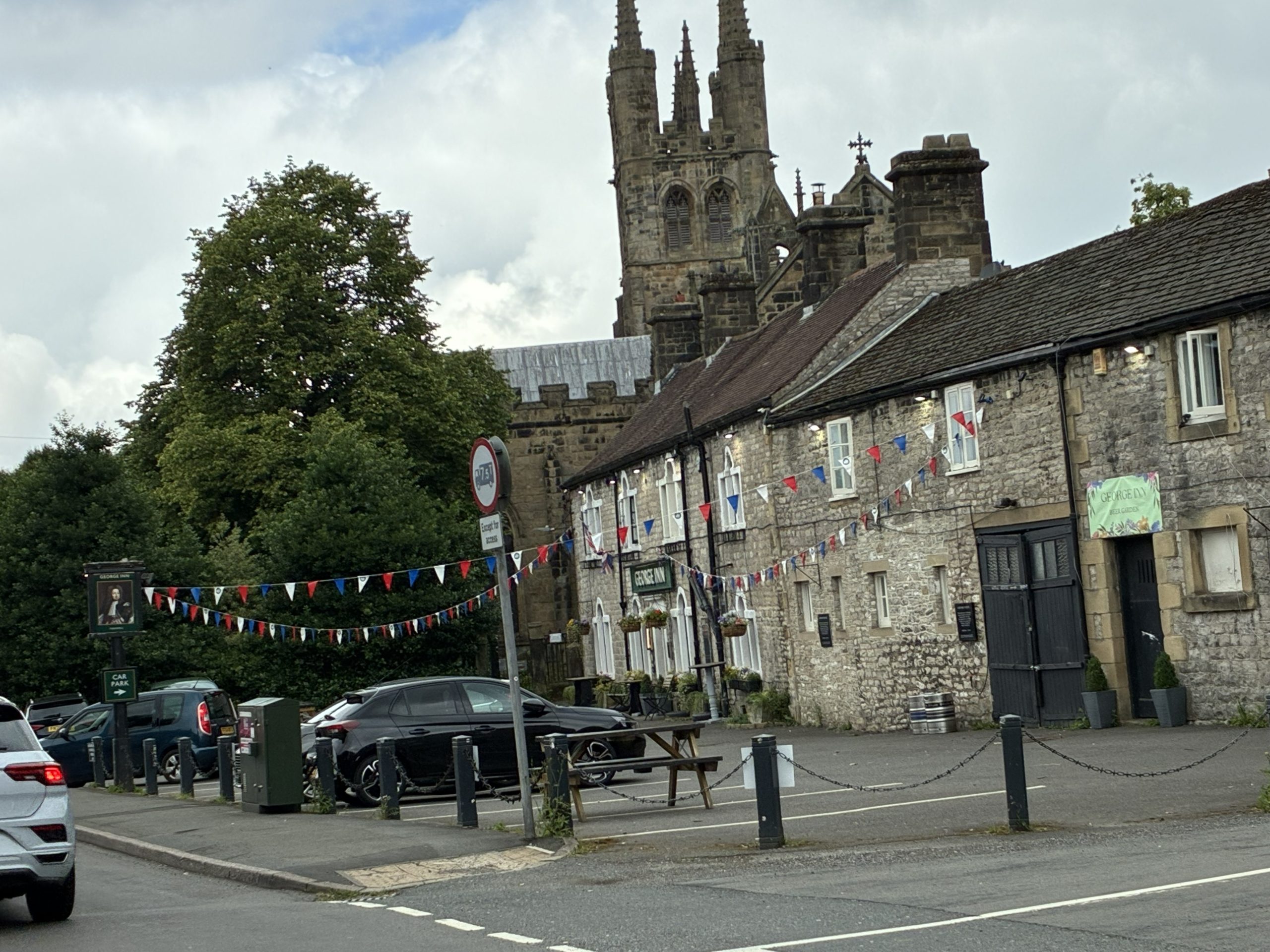 Explore the Market Towns – View towards Tideswell town centre with the historic parish church in the background, Peak District.